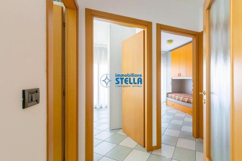 a hallway with a room with a bed at Villaggio Papaia in Lido di Jesolo