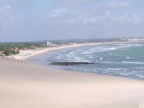 an aerial view of a beach with the ocean at Pousada Aconchego de Genipabu in Jenipabu