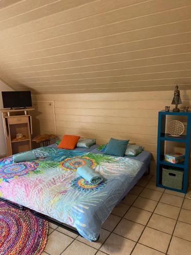 a bedroom with a bed with a computer mouse on it at Zauber-Appartment in Krombach