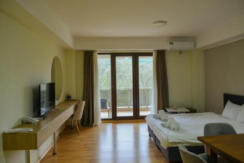a hotel room with two beds and a television at Park Golden View Hotel Casino in Ohrid