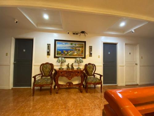 a dining room with a table and two chairs at North Shores Inn in Currimao