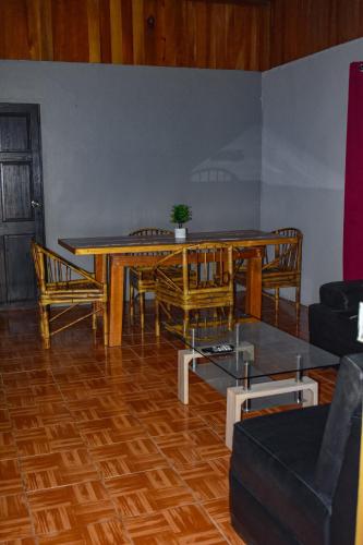 a living room with a wooden table and chairs at Finca Makambu in Platanillo