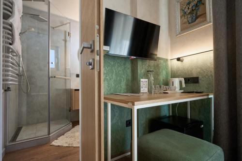 a bathroom with a sink and a shower at Hotel Vedmezhyi Dvir in Bukovel