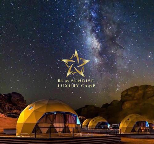 a group of tents under a starry sky at RUM SUNRlSE LUXURY CAMP in Wadi Rum