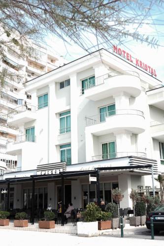 a white hotel with a sign on the front of it at Hotel Kristal in Durrës