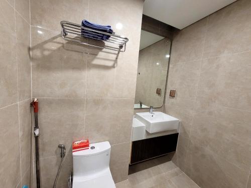 y baño con aseo, lavabo y espejo. en Na Mit HomeStay, en Hai Phong