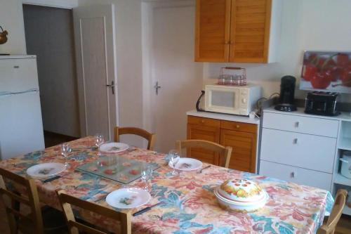 a kitchen with a table with a cake on it at Appartement de 2 chambres avec jardin amenage et wifi a Rosureux in Rosureux