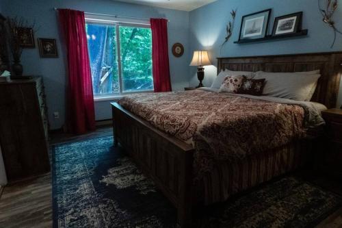 a bedroom with a large bed and a window at Spacious Catskills Home with Covered Hot Tub in Monticello