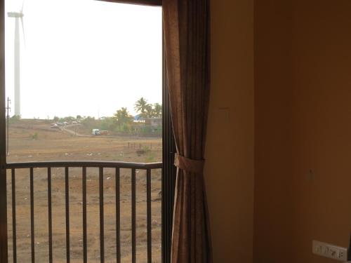 a room with a window with a view of a field at SV Inns Sea Pearl in Devgarh
