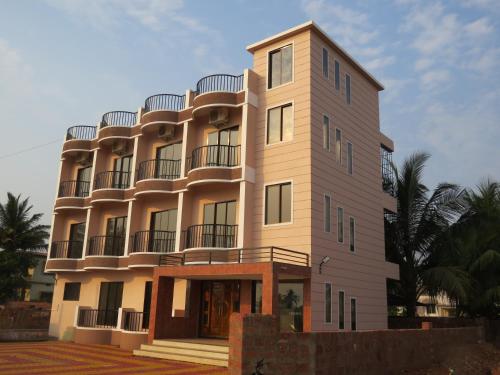 a building with balconies on the side of it at SV Inns Sea Pearl in Devgarh