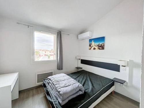een slaapkamer met een bed, een bureau en een raam bij 3303 - maison avec piscine in Argelès-sur-Mer
