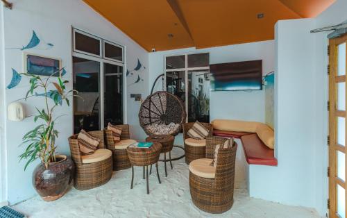 a living room with wicker chairs and a couch at Karanka Villa @ Mahibadhoo in Mahibadhoo