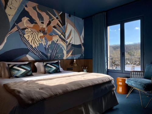 a bedroom with a bed and a large window at Les Etangs de Corot in Ville-dʼAvray