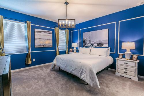 a blue bedroom with a large bed and blue walls at StarWar Retreat 3D 12BR 11.5BA Villa Pool BBQ in Kissimmee
