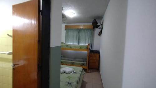 a small room with a bunk bed in a room at Hostería Cerros Dorados de Cosquín in Cosquín