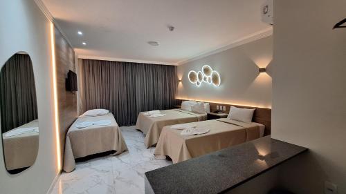 a hotel room with two beds in a room at Pousada Marítimos in Maragogi
