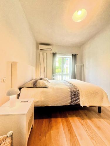 une chambre avec un grand lit et une fenêtre dans l'établissement La petite Bastide, à Cassis