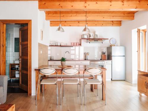 a kitchen with a dining table and chairs at Apartment House Blazar in Tolmin