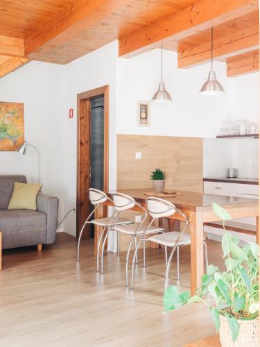 a kitchen and living room with a table and chairs at Apartment House Blazar in Tolmin