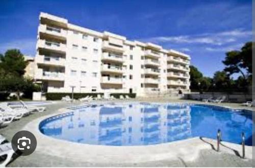 a large swimming pool in front of a large building at Family Relax Salou in Salou