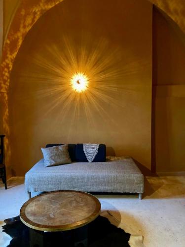 a bedroom with a bed with a table and a ceiling at Antica Masseria le Monache in Grottaglie
