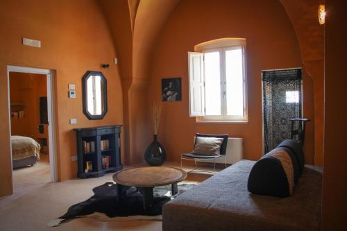 a living room with a couch and a table at Antica Masseria le Monache in Grottaglie