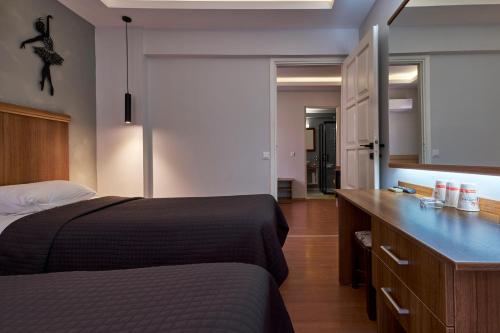a bedroom with a bed and a dresser and a mirror at Aqua Princess Hotel in Kaş