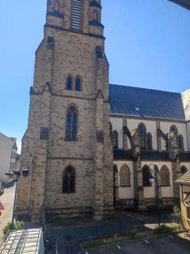 a large brick building with a clock tower at Chez Dori Chambre privée in Bischheim