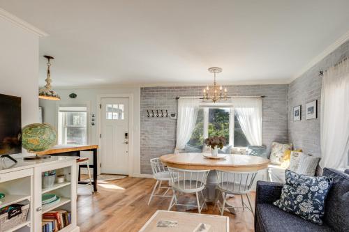 a living room with a table and a couch at Quaint Sur La Mer Cottage with Deck, Fire Pit in Seaside