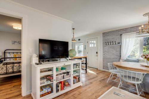 a kitchen and dining room with a flat screen tv at Quaint Sur La Mer Cottage with Deck, Fire Pit in Seaside