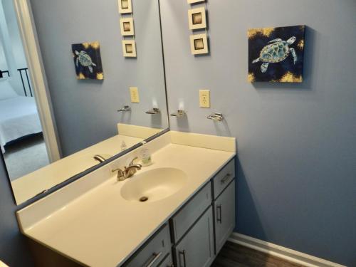a bathroom with a sink and a mirror at 35B GCR Everything Zen A Quiet Escape in Myrtle Beach