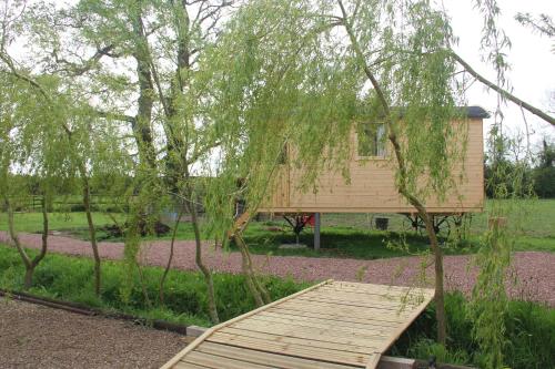 a wooden bridge in front of a house at LOGIS DU GRAND PIN in Saint-Martin-des-Entrées