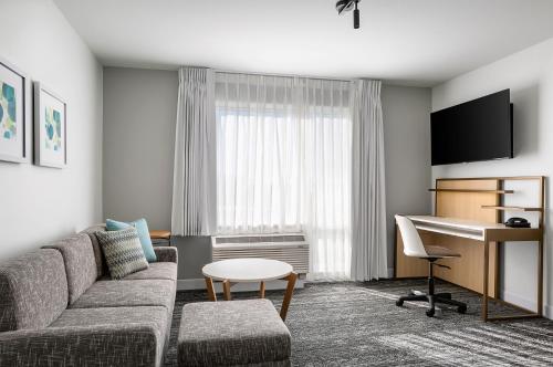 a living room with a couch and a desk at TownePlace Suites by Marriott Iron Mountain in Iron Mountain