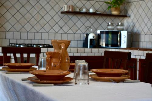 a table with plates and bowls on top at Casa Le Radici-Castro in Castro di Lecce