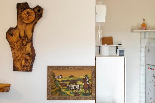 a piece of wood hanging on a wall next to a refrigerator at Tenuta Ponte Vecchio in Bortigiadas