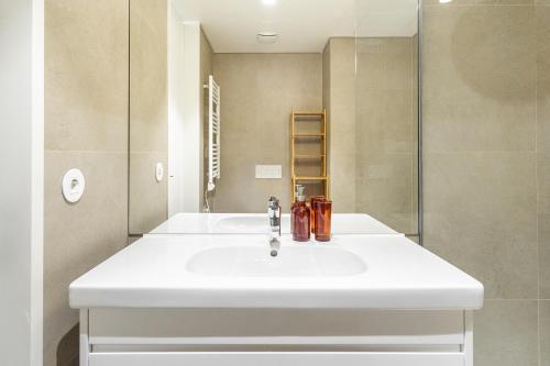 a bathroom with a white sink and a shower at WHome Top Floor w Luxury Design Premium Location in Lisbon