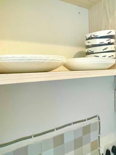 a shelf with two plates and bowls on it at Pazuri Homes 2BD Apartment in Mombasa