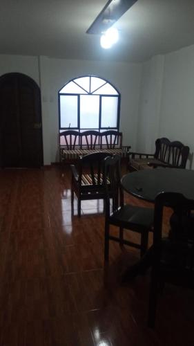 an empty room with tables and chairs and a window at Casa Bonita in Cajamarca