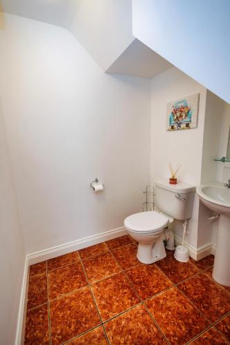 a bathroom with a toilet and a sink at 15 Killarney Holiday Village in Killarney