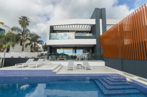 a house with a swimming pool next to a building at Buganvilia - Luxury villa - private pool by HD in Vale Formoso