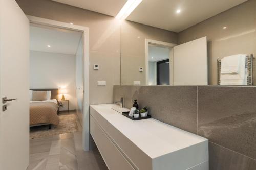 a bathroom with a sink and a mirror at Buganvilia - Luxury villa - private pool by HD in Vale Formoso