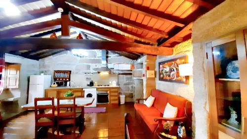 a kitchen and living room with a couch and a table at Charming house in Lindoso with terrace and parking included in Lindoso