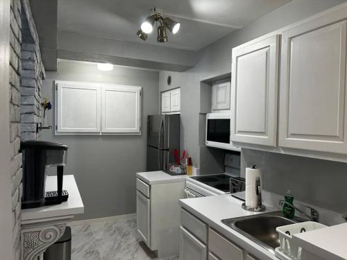 a kitchen with white cabinets and white appliances at Walk To Goodspeed Opera House from this quaint 2 BDRM APT in East Haddam