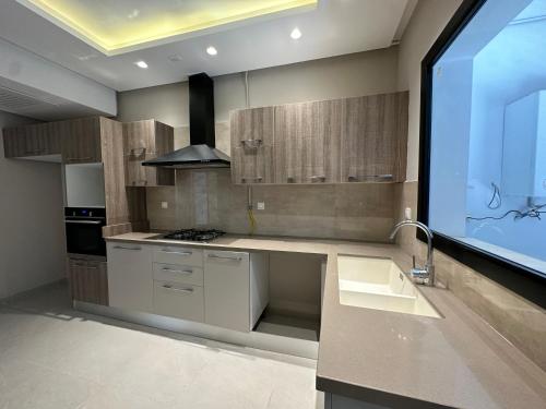 a kitchen with a sink and a stove at Luxury apartment s2 in Sidi Daoud