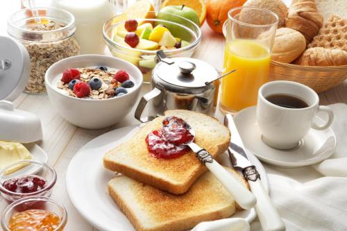 a table with a plate of breakfast food with toast at Sheraton Philadelphia Downtown in Philadelphia