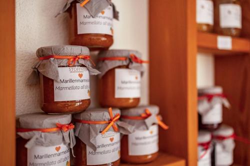 a group of jars of honey on a shelf at Stoffnerhof Apt Sonnenblume in Tesido