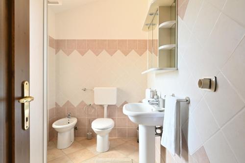 uma casa de banho com um WC e um lavatório em La dolce vita Barisardo em Bari Sardo