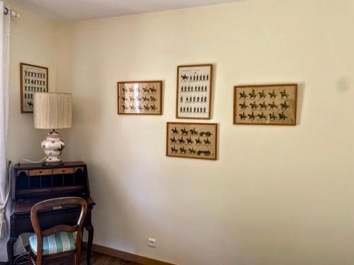 a room with a table and four pictures on the wall at Domaine de Bertranet - Chambres D'Hôtes in Tonneins