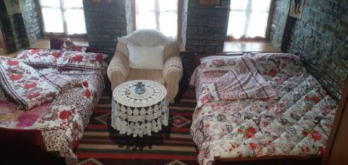 a living room with two beds and a couch at guest house in buhal in Përmet