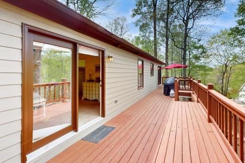 a large wooden deck on the side of a house at 1 Special Place in Moneta